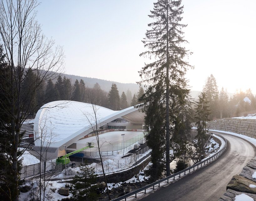 graft constructs dramatic curved roof over feuerstein arena in germany
