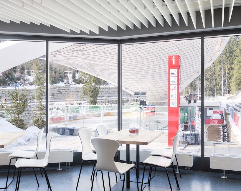 graft constructs dramatic curved roof over feuerstein arena in germany