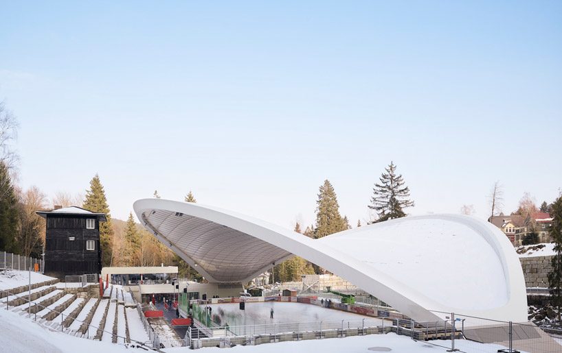 graft constructs dramatic curved roof over feuerstein arena in germany