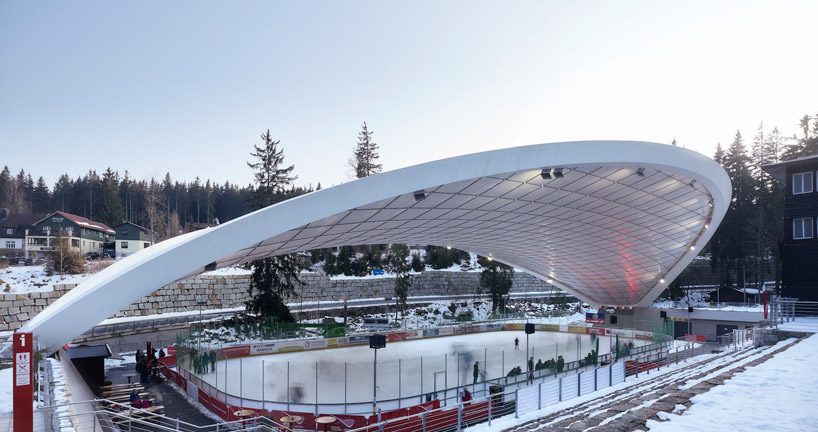 graft constructs dramatic curved roof over feuerstein arena in germany