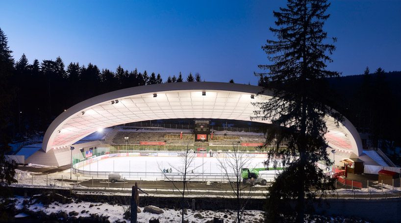 graft constructs dramatic curved roof over feuerstein arena in germany