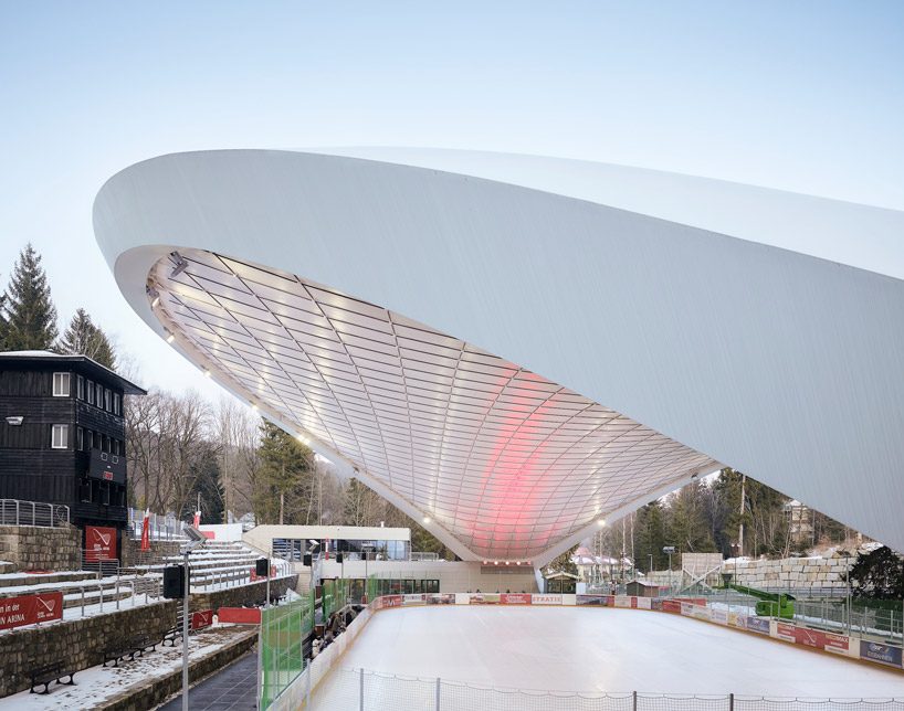 graft constructs dramatic curved roof over feuerstein arena in germany