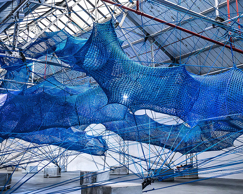 numen/for use constructs adult playground of woven blue tunnels in london car park