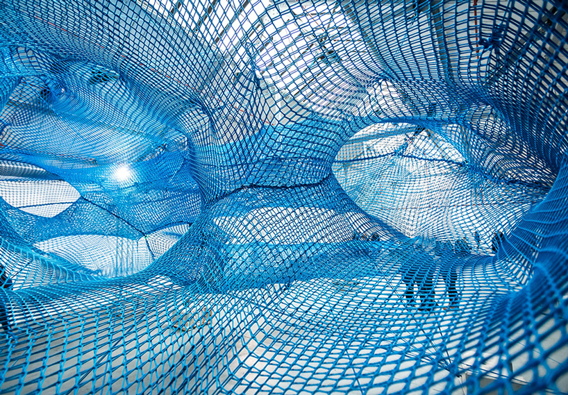 numen/for use constructs adult playground of woven blue tunnels in london car park