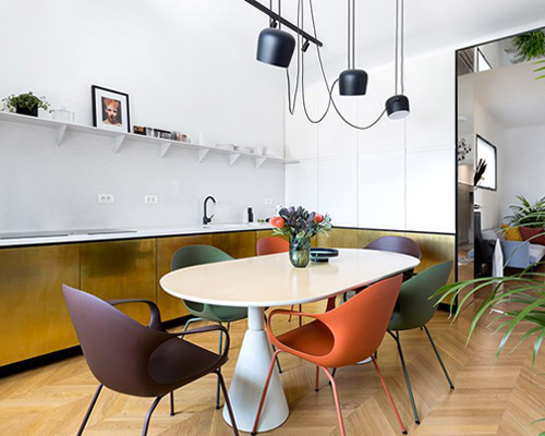 bogdan ciocodeica studio uses brass finishes to renovate a 1930's apartment in bucharest