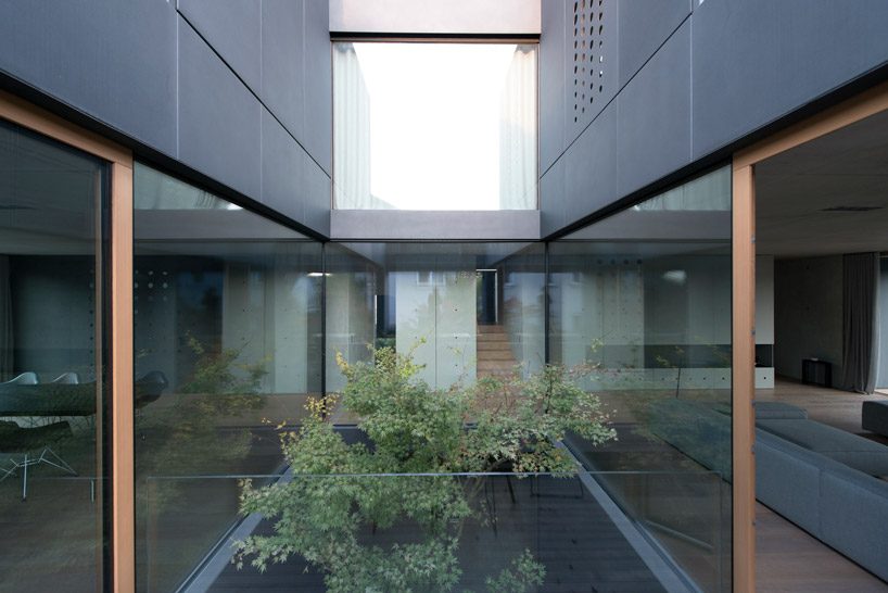 OFIS inserts an internal glazed atrium in the heart of 'house portico' in ljubljana designboom