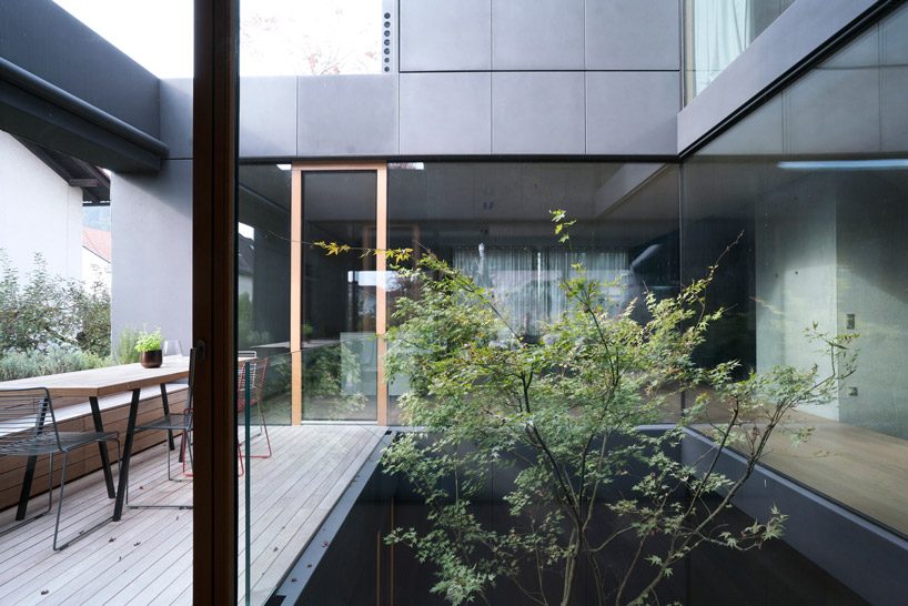 OFIS inserts an internal glazed atrium in the heart of 'house portico' in ljubljana designboom