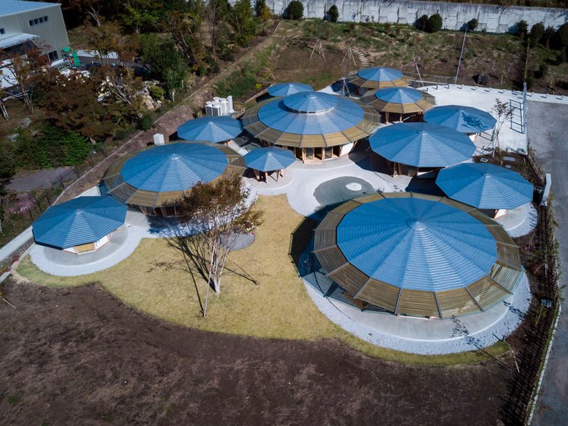 tezuka architects forms array of round timber structures for 'muku nursery' in japan designboom