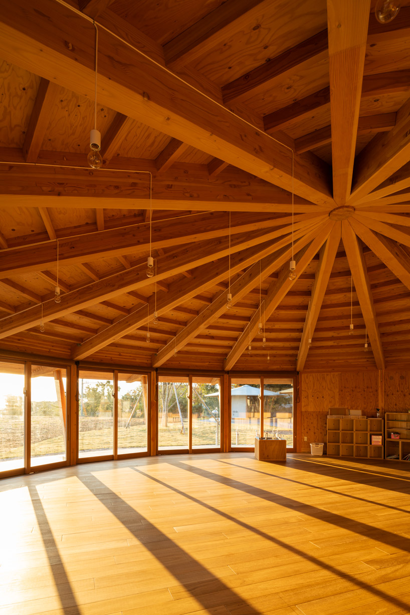 tezuka architects forms array of round timber structures for 'muku nursery' in japan designboom