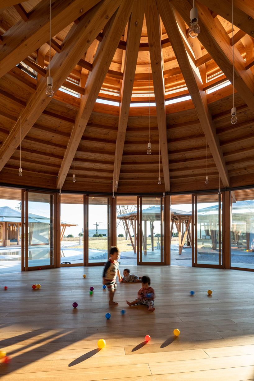 tezuka architects forms array of round timber structures for 'muku nursery' in japan designboom
