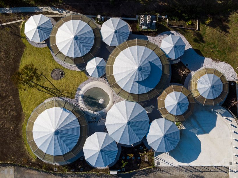 tezuka architects forms array of round timber structures for 'muku nursery' in japan designboom