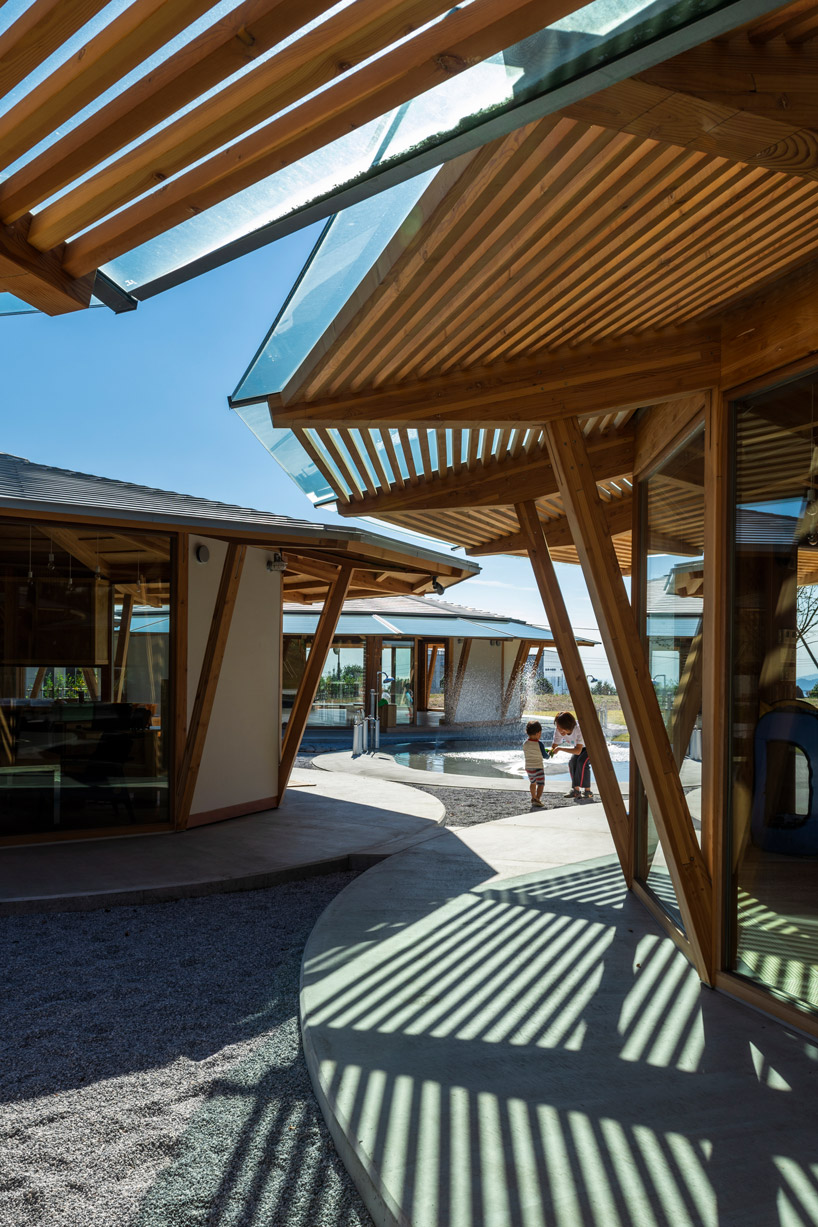 tezuka architects forms array of round timber structures for 'muku nursery' in japan designboom