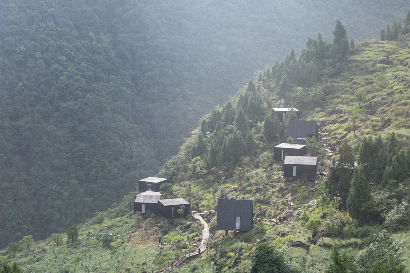 ZJJZ builds charred timber volumes on a hillside in rural china for 'woodhouse hotel' designboom