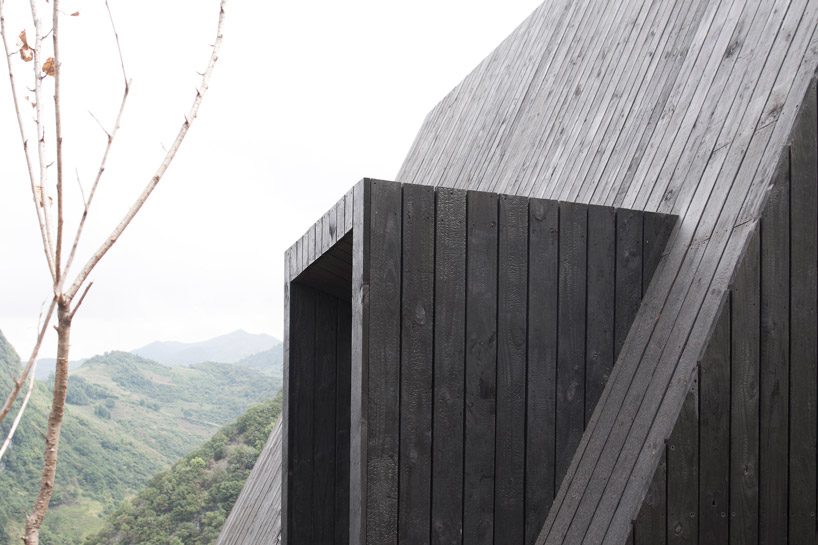 ZJJZ builds charred timber volumes on a hillside in rural china for 'woodhouse hotel' designboom