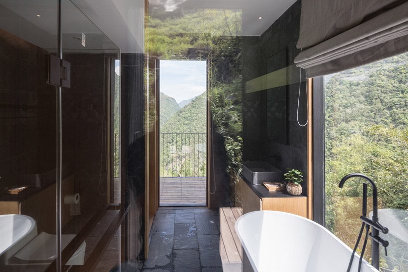 ZJJZ builds charred timber volumes on a hillside in rural china for 'woodhouse hotel' designboom