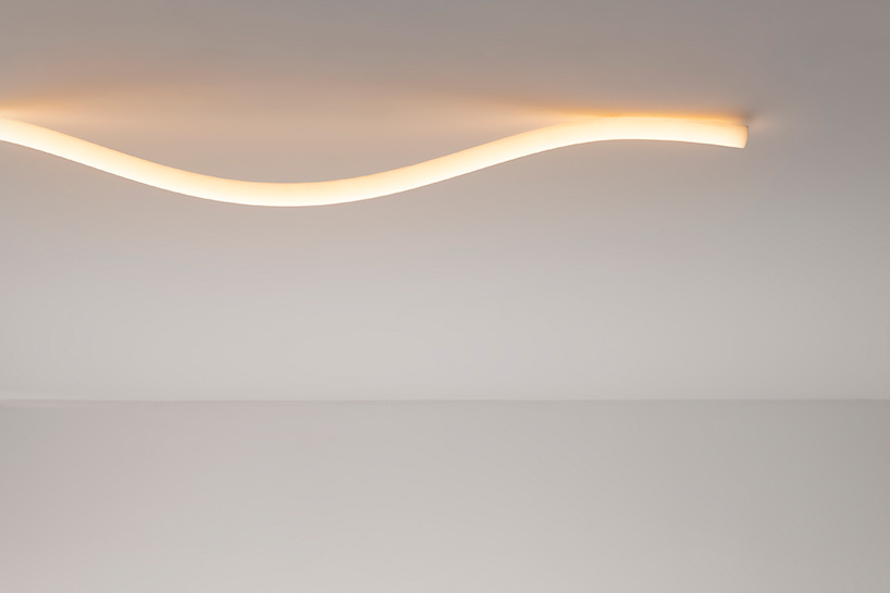 la linea by BIG for artemide, a luminous strip that moves freely in space designboom