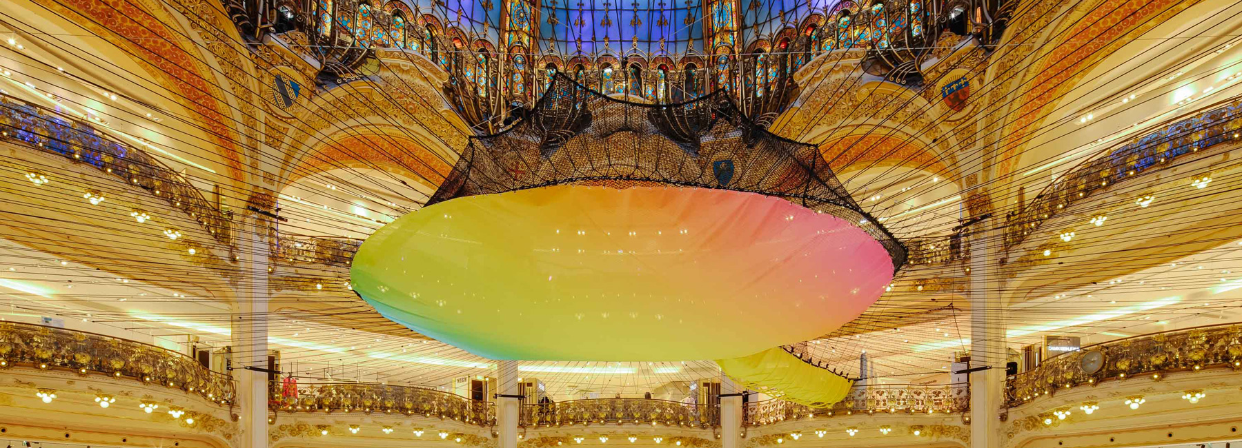 Suspended Rainbow Net Stretches In The Middle Of Galeries