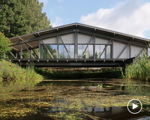 bridge house by bio-architects hovers over creek in russian forest