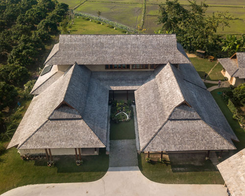 adobe brick and timber create a contemporary 'tale of earth and wood' in thailand