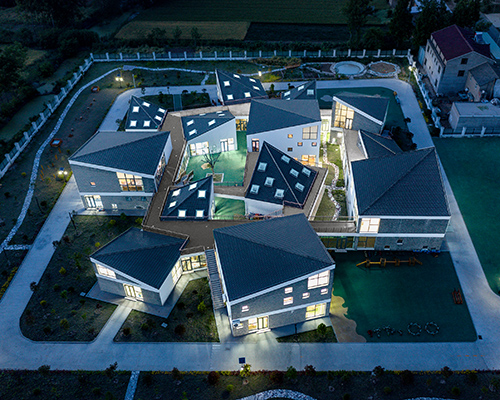 kindergarten in rural china organized as a 'mini village' of scattered volumes