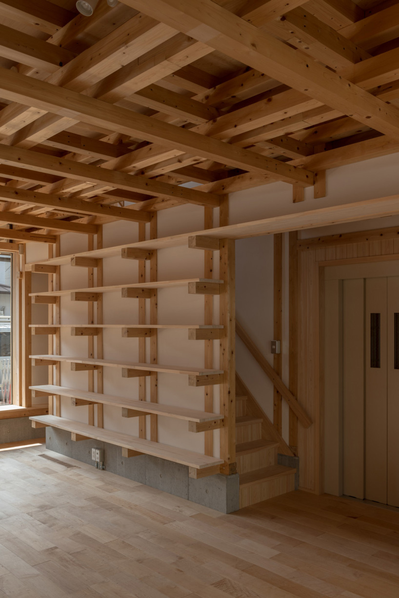kazuya morita builds wooden lattice frame structure for archive library in kyoto