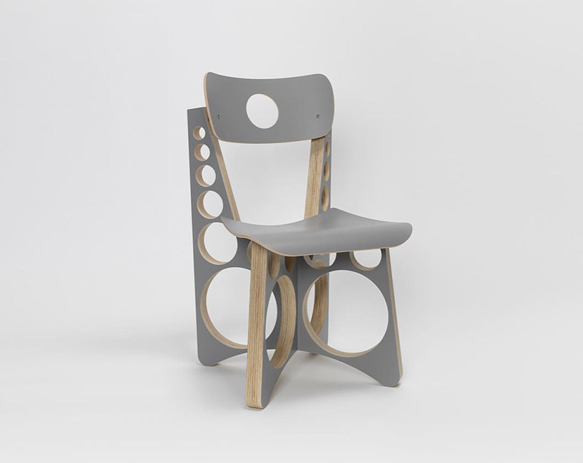 tom sachs punctuates circular holes throughout limited gray edition of shop chair designboom
