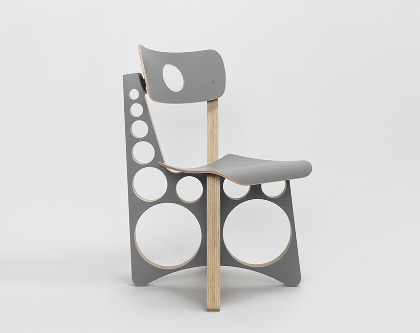 tom sachs punctuates circular holes throughout limited gray edition of shop chair designboom