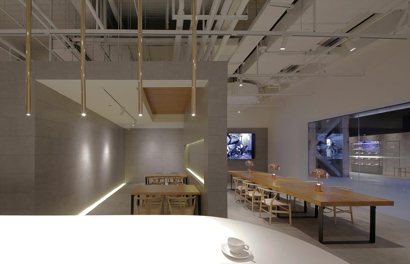 jun murata / JAM uses exposed concrete and brass accents for shanghai's cafe la loop 86 designboom