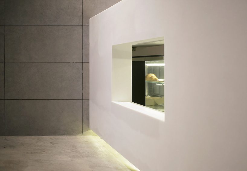 jun murata / JAM uses exposed concrete and brass accents for shanghai's cafe la loop 86 designboom