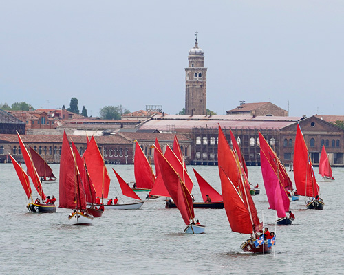 melissa mcgill choreographs 50 traditional sailboats with red sails in the venetian lagoon