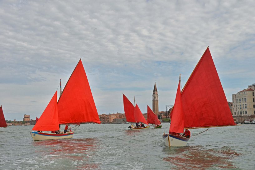 melissa mcgill choreographs 50 traditional sailboats with red sails in the venetian lagoon