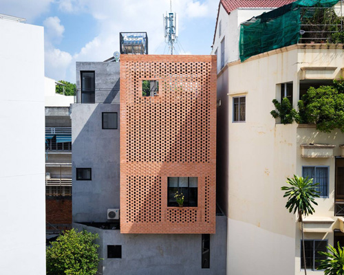 tropical space combines perforated clay brick + concrete for NDC house in vietnam