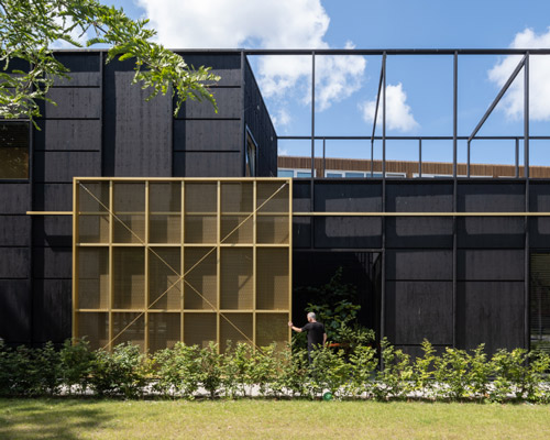 all-black 'house M&M' in amsterdam is accessed via a giant sliding door