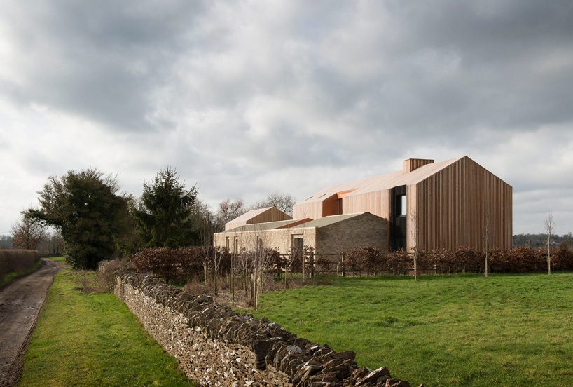  bureau de change combines interlocking barn volumes for house in rural england