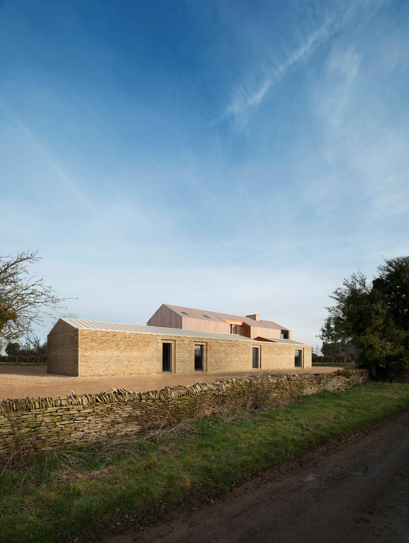  bureau de change combines interlocking barn volumes for house in rural england