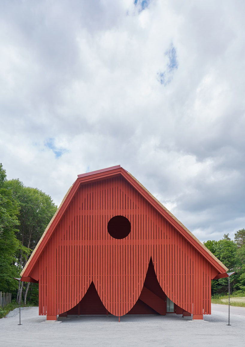 sandellsandberg clads swedish wildlife park building in playful red wooden drapes