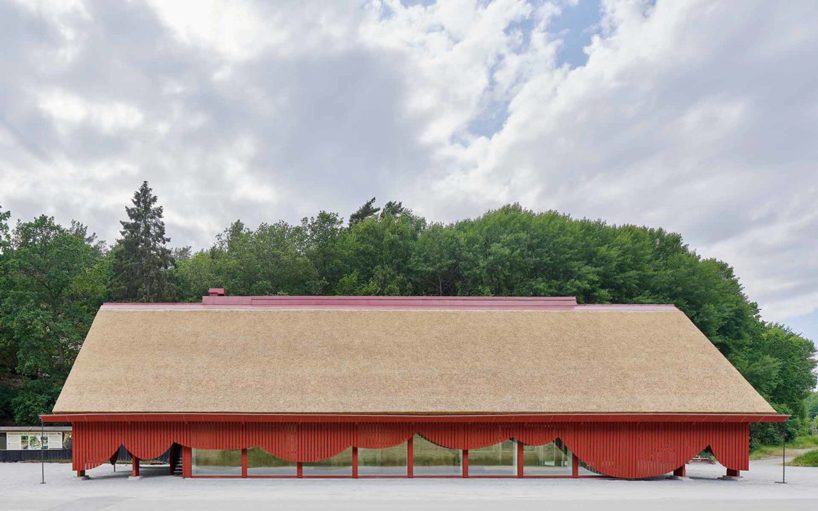 sandellsandberg clads swedish wildlife park building in playful red wooden drapes
