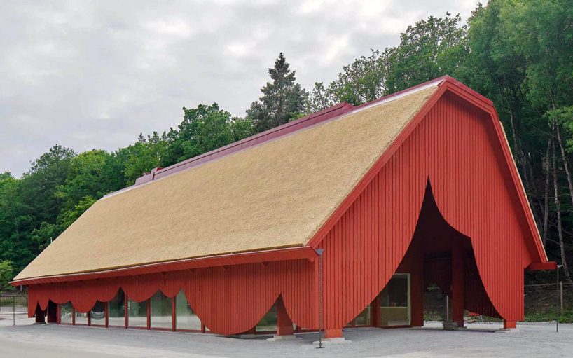 sandellsandberg clads swedish wildlife park building in playful red wooden drapes