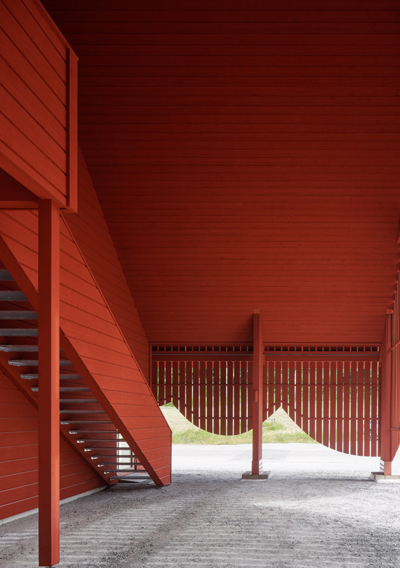 sandellsandberg clads swedish wildlife park building in playful red wooden drapes