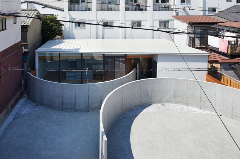 fujiwaramuro architects uses arched concrete walls to divide areas in this house in osaka