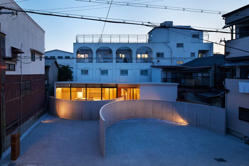 fujiwaramuro architects uses arched concrete walls to divide areas in this house in osaka