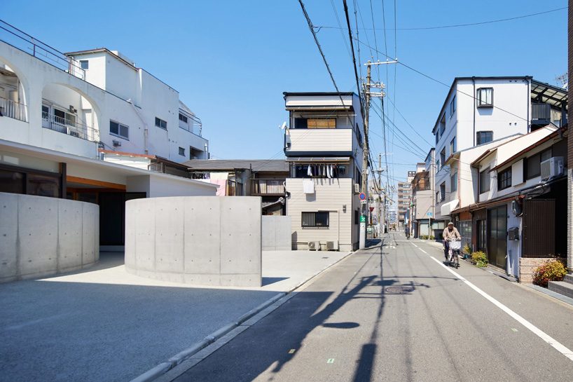 fujiwaramuro architects uses arched concrete walls to divide areas in this house in osaka