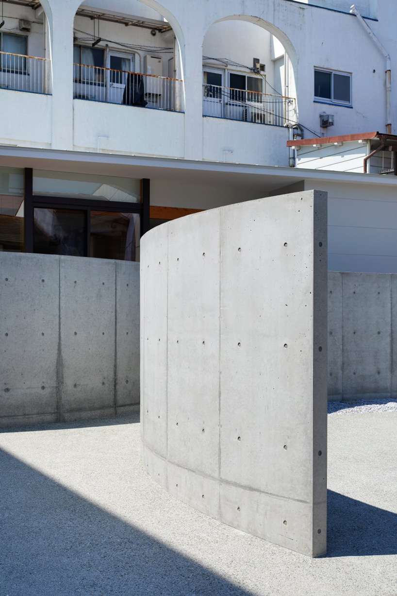 fujiwaramuro architects uses arched concrete walls to divide areas in this house in osaka