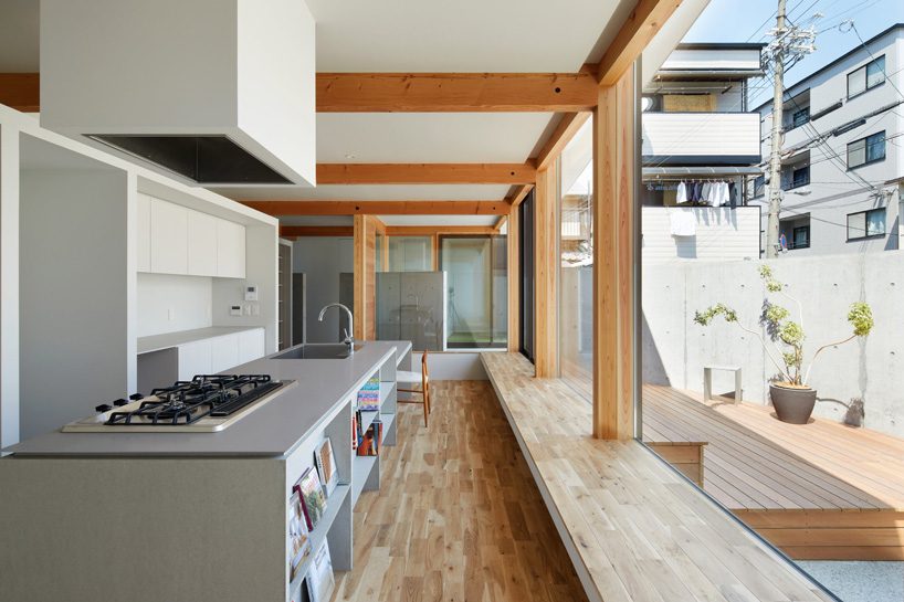 fujiwaramuro architects uses arched concrete walls to divide areas in this house in osaka