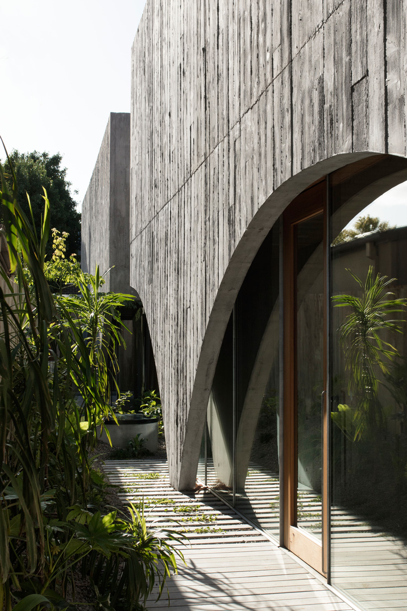 edition office combines pair of arched concrete shells for house in hawthorn, australia