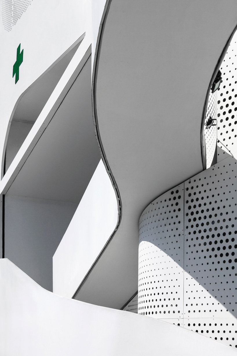  klab architecture completes pharmacy with triangular perforated façade in piraeus, greece