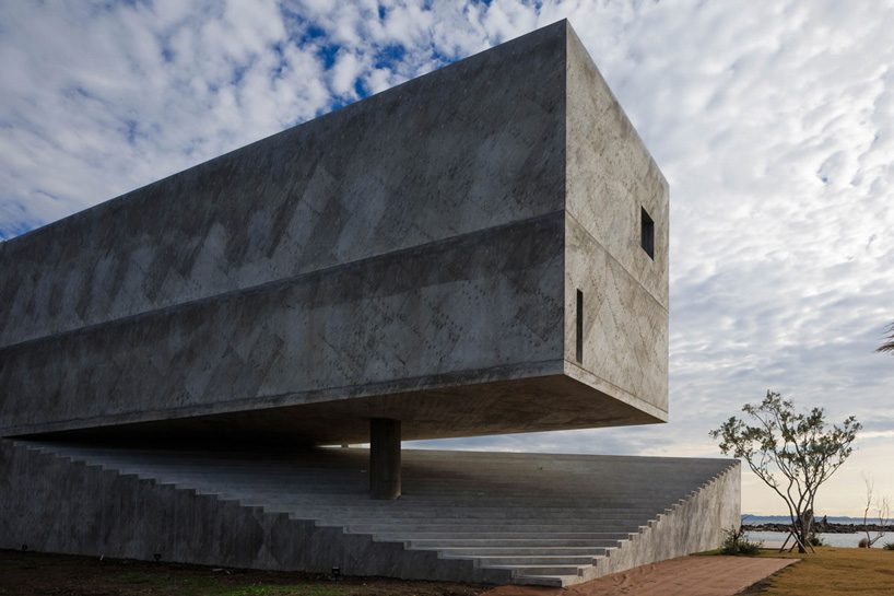 mount fuji architects studio's concrete residence emerges from a rocky peninsula in japan