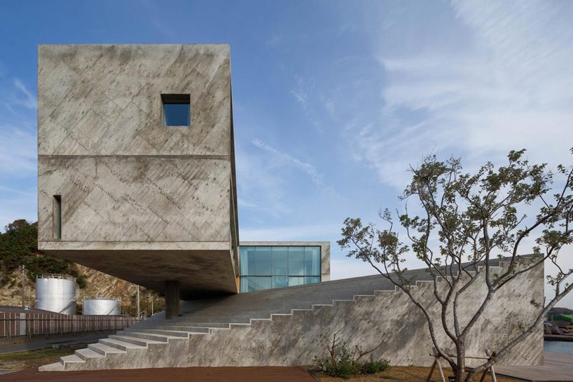 mount fuji architects studio's concrete residence emerges from a rocky peninsula in japan