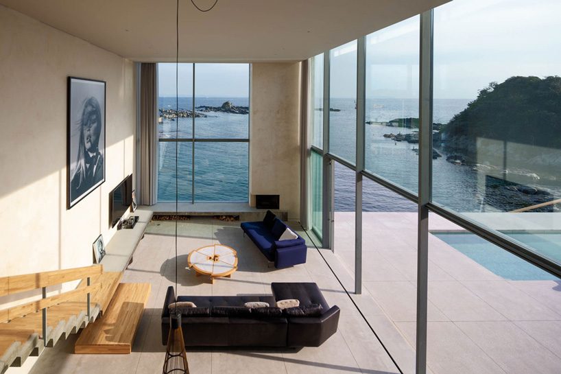 mount fuji architects studio's concrete residence emerges from a rocky peninsula in japan