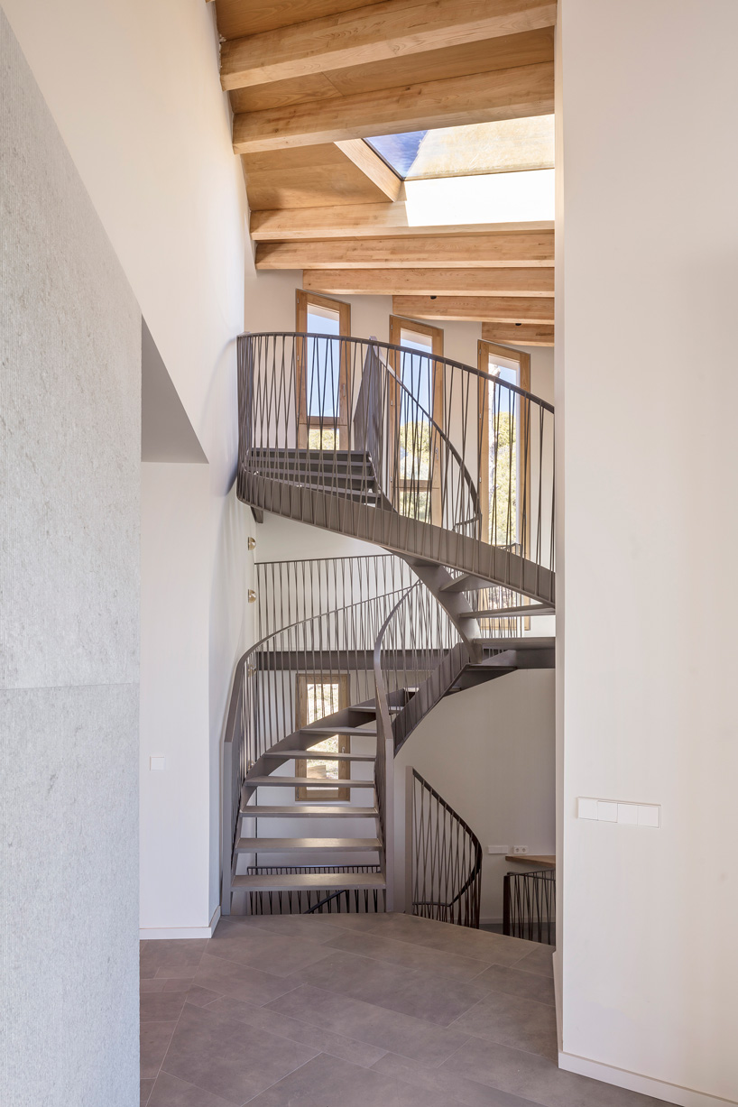 05 AM arquitectura's mediterranean house cascades down a steep slope in tamariu, spain